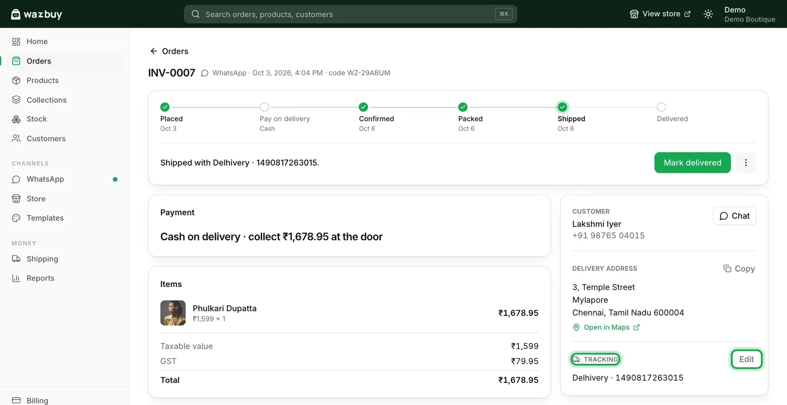 An order page in WazBuy. The steps bar shows Placed, Confirmed, Packed and Shipped. The order was shipped with Delhivery with a tracking number, paid by cash on delivery, with the taxable value, GST, customer and delivery address.